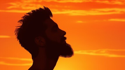 Silhouette of a young man against a vibrant sunset, capturing the essence of summer vacation vibes in a stunning side view.