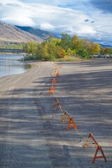 Autumn Beach Scene with Safety Cones