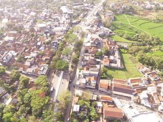Aerial view of serene countryside with Long Road and lush greenery, Cicalengka, Indonesia. An alternative route that cuts through the mountains. Economy, Business and Transportation.