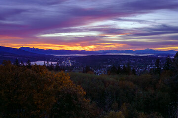 Fototapeta premium Sunrise over Fraser Valley, BC, with mountains in silhouette on horizon.