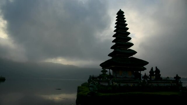 Pura Ulu Danau Temple Bali travel Indonesia Destination Exotic Place of worship in Silhouette. Lake temple Indonesian Culture Tranquil Scene Idyllic Tourism Balinese Hinduism Pagoda Beauty In Nature