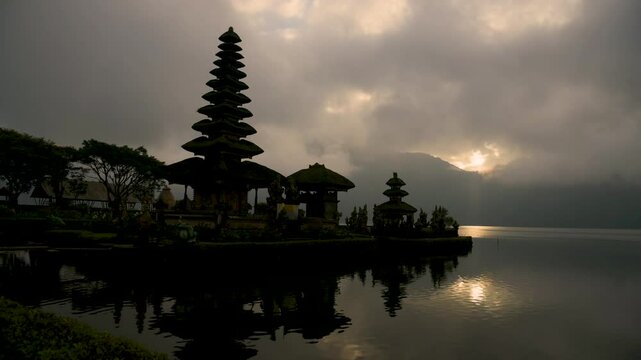 Pura Ulu Danau Temple Bali travel Indonesia Destination Exotic Place of worship in Silhouette. Lake temple Indonesian Culture Tranquil Scene Idyllic Tourism Balinese Hinduism Pagoda Beauty In Nature