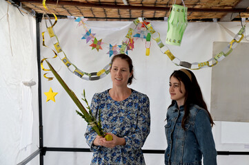 Jewish mother and daughter blessing on the four species on the Jewish holiday of Sukkot