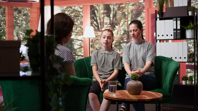Therapist expert does a family counseling session for emotional management, helping a mother and teenage girl navigate mental health issues. Psychotherapy for adolescent development. Camera B.
