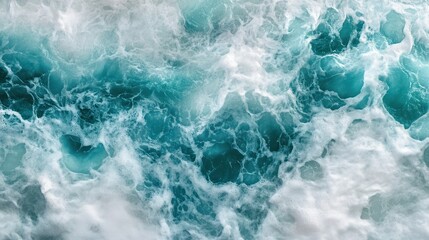 Fototapeta premium Overhead view of turquoise ocean water with white foamy waves.