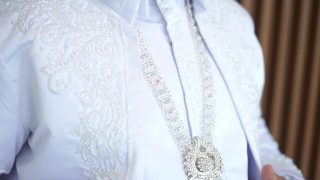 A groom in a white akad suit, exuding charm and grace on his special day. Ideal for wedding, cultural, or fashion projects showcasing love and commitment