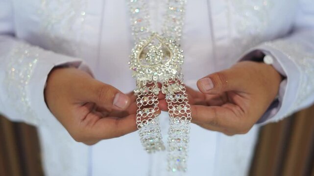 A groom in a white akad suit, exuding charm and grace on his special day. Ideal for wedding, cultural, or fashion projects showcasing love and commitment