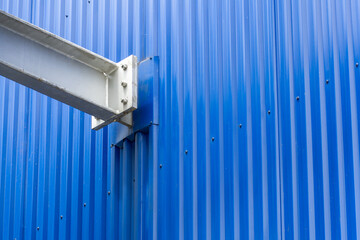 A close up of steel beams creating a geometric pattern in a modern urban architectural structure. The composition showcases industrial design and engineering precision