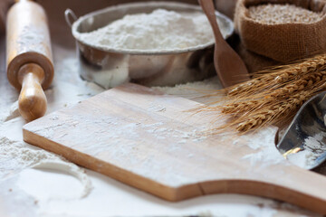 Wooden cutting board with rice flour, white wheat flour With ears of rice, natural agricultural food, top view
