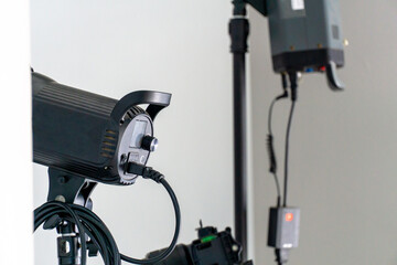 professional lighting equipment in studio. black lighting studio with white background and cable