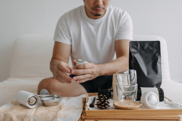 Step by step of Asian man making espresso with hand press tools.