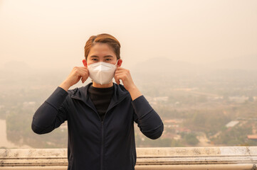 Asian woman wearing N95 mask for protect Bad air pollution (PM2.5).