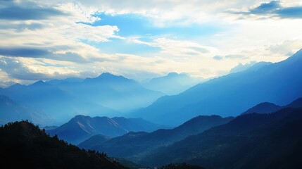 Fototapeta premium Serene mountain landscape with soft clouds and distant peaks.