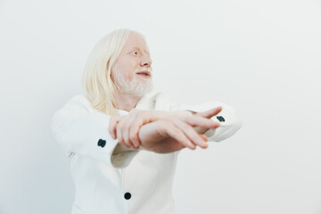 Elderly man stretching against a neutral background, showcasing a sense of wellness and vitality...