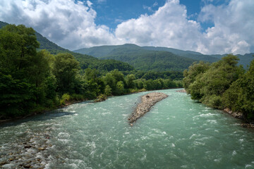 View of the Bolshoy Zelenchuk River in the northern foothills of the Caucasus Mountains near the village of Nizhny Arkhyz on a summer day, Karachay-Cherkessia, Russia