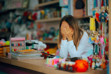 Sad Unhappy Saleswoman Feeling Exhausted at the Counter. Tired store manager feeling depressed and...