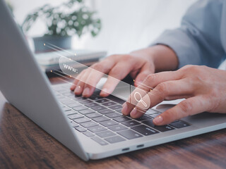 Businessman using laptop computer searching browsing Internet data information and working on...
