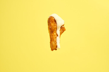 Hot Buffalo Chicken Wing Drumstick Isolated on Yellow Background with Ranch