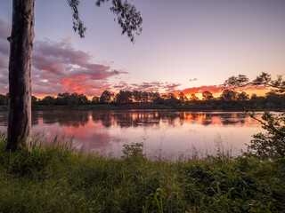 Naklejka premium Sunset by the River with Reflections