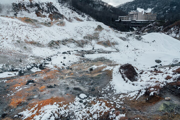 Steam hot springs and snow scene in Noboribetsu Hell Valley, Hokkaido, Japan