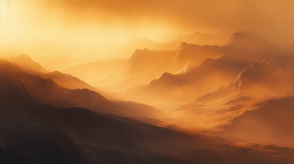 Obraz premium A misty mountain range with the sun setting behind them, creating a warm golden glow.
