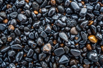 Close-up of black and brown pebbles with smooth textured surface