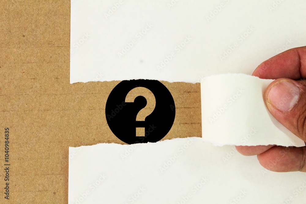 Poster hand opening torn paper with question symbol. the concept of finding answers. question mark signs on