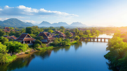 Fototapeta premium Village on a riverbank with small bridges connecting homes, calm river reflecting the bright blue sky, green trees around