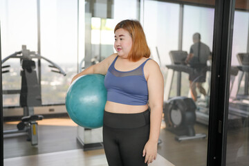 Fototapeta premium Sporty woman exercising on ball&nbsp;fitness workout and health concept. training working out and sitting on gymnastic fitball&nbsp;at gym
