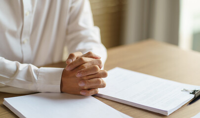 Business man crossed hands for waiting and holding hands feel worried Impotency.