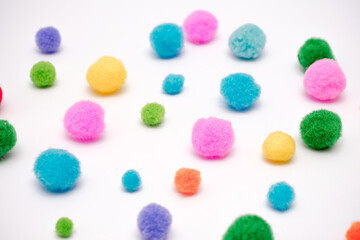 A bunch of pom poms in various colors