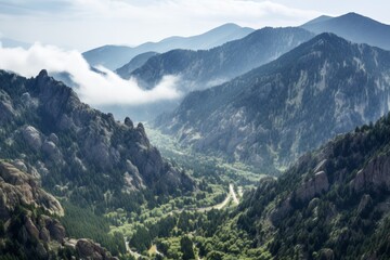 Obraz premium Serene clouds gracefully drifting over a breathtaking mountain valley landscape at dusk