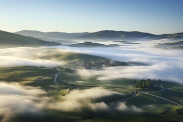 Spinning wind turbines gracefully rise over lush green hills under a clear blue sky