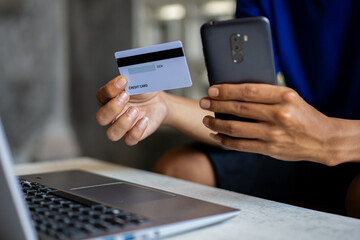 hands holding cell phones and credit cards, the concept of online transactions