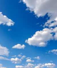 Fototapeta premium A peaceful scene of a blue sky dotted with soft, white cumulus clouds, perfect for backgrounds and design.