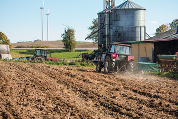 Farm with a tractor and a silo © Lukasz Jasionowski