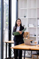 Document businesswoman hand working in finance department of paper files for searching and checking unfinished documents achieves folders papers at busy work desk office
