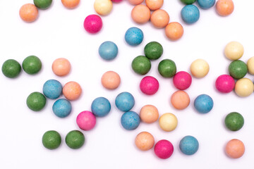 Bunch of colorful candy balls are scattered on a white background