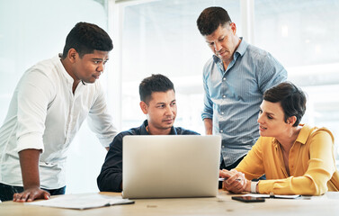 Obraz premium Business, people and team with laptop in office for website development or user interface design planning. Web designer, collaboration or documents in meeting for brainstorming together or discussion