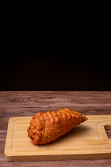Piece of meat is sitting on a wooden cutting board
