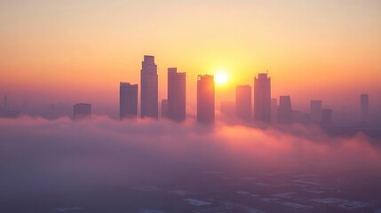 Fototapeta premium A panoramic view of a city skyline with skyscrapers emerging from a sea of fog at sunrise.