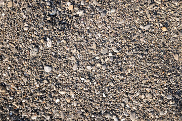 A close up of a rocky surface with a lot of small rocks scattered around