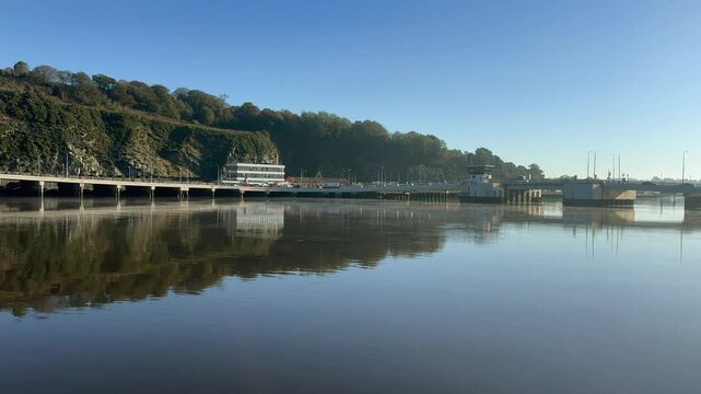 Vehicle traffic crossing Rice Bridge on calm, sunny Waterford IRL day