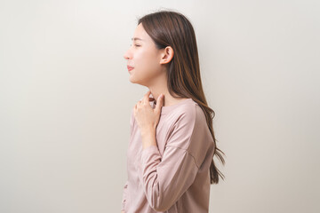 Sickness in inflaming asian young woman, girl use hand check self touch at sore throat, pain...