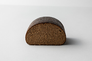 Sliced Dark Rye Bread Loaf Showing Textured Crumb on white background