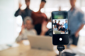 Phone screen, business people and video call for group in office with wave, hello and contact with app. Team, smartphone ux and virtual meeting with greeting, conference or webinar on mobile network