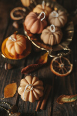 Handmade wax candle in the shape of pumpkins on a dark background