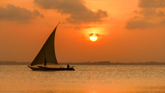 Sunset on a Zanzibar beach with a traditional dhow