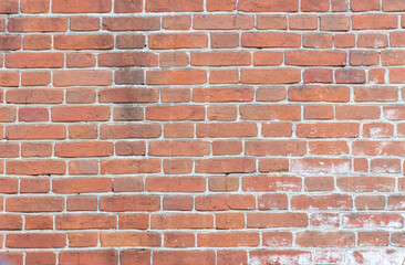 A brick wall with a few bricks missing