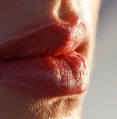 A woman's lips are red and shiny